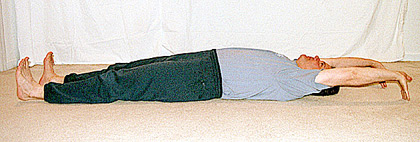 Student lying on his back, stretching out 