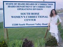 Nikki standing in front of the sign for the correctional center